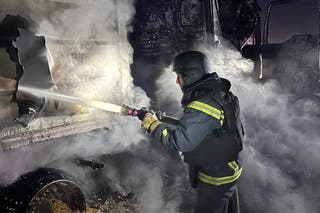 A firefighter works at the site of a Russian missile and drone strike in Odesa